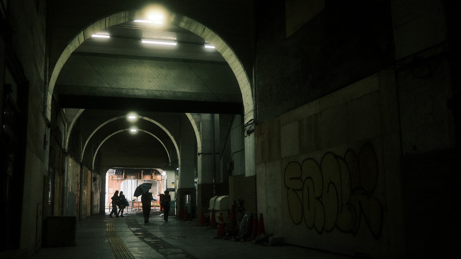 Under the tracks, toward the light.